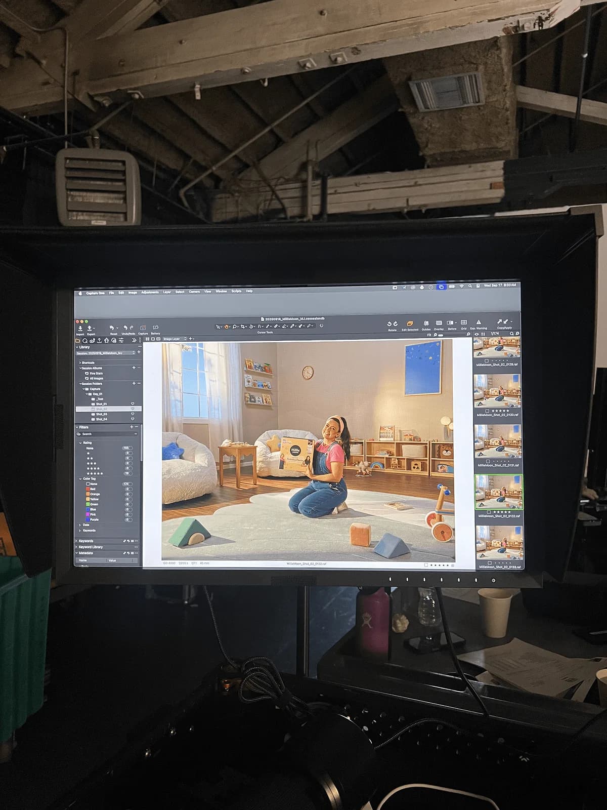 Studio monitor showing Ms. Rachel on a playroom set holding a box of Millie Moon Luxury Training Pants