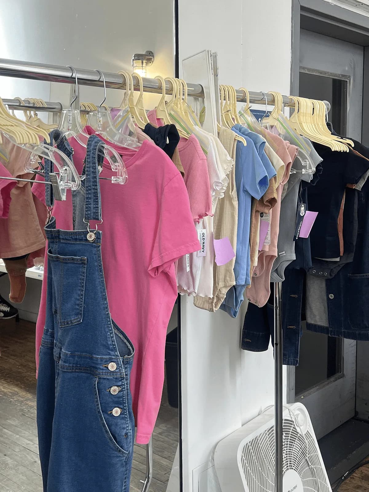Wardrobe rail of clothing backstage at the Ms. Rachel x Millie Moon photo shoot